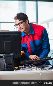 Computer repairman working on repairing computer in IT workshop. The computer repairman working on repairing computer in it workshop