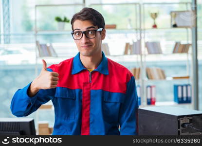 Computer repairman working on repairing computer in IT workshop