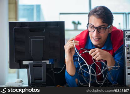 Computer repairman working on repairing computer in IT workshop