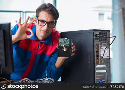 Computer repairman working on repairing computer in IT workshop