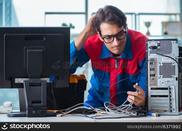 Computer repairman working on repairing computer in IT workshop