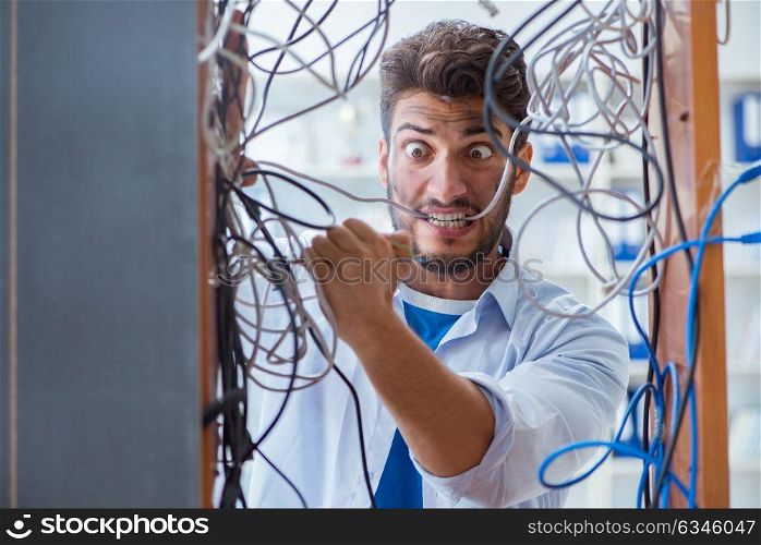 Computer repairman working on repairing network in IT workshop