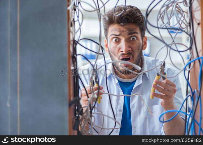 Computer repairman working on repairing network in IT workshop