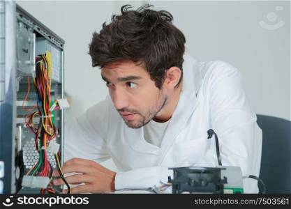 computer specialist checking central unit