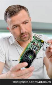 Computer specialist looking at a video card