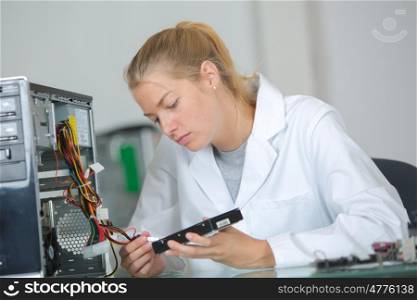 computer technician fixing a motherboard