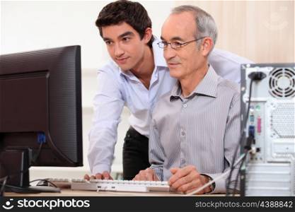 Computer technician helping office worker