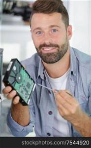 computer technician holding hard drive