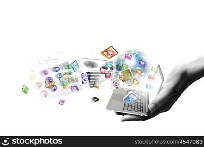 Computer technologies. Close up of hand with laptop and media icons. Elements of this image are furnished by NASA
