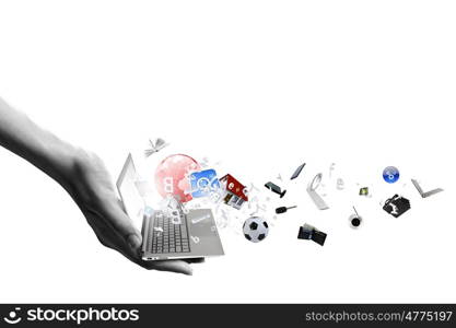 Computer technologies. Close up of hand with laptop and media icons