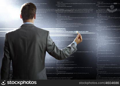 Computer technologies. Rear view of businessman touching icon of media screen