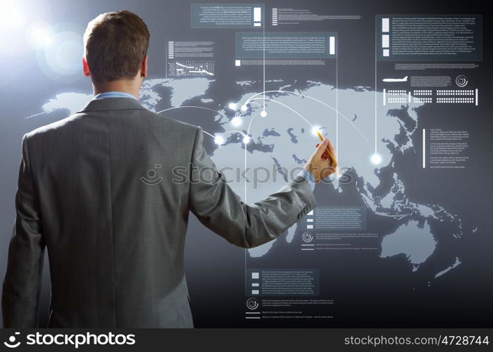 Computer technologies. Rear view of businessman touching icon of media screen