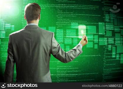 Computer technologies. Rear view of businessman touching icon of media screen