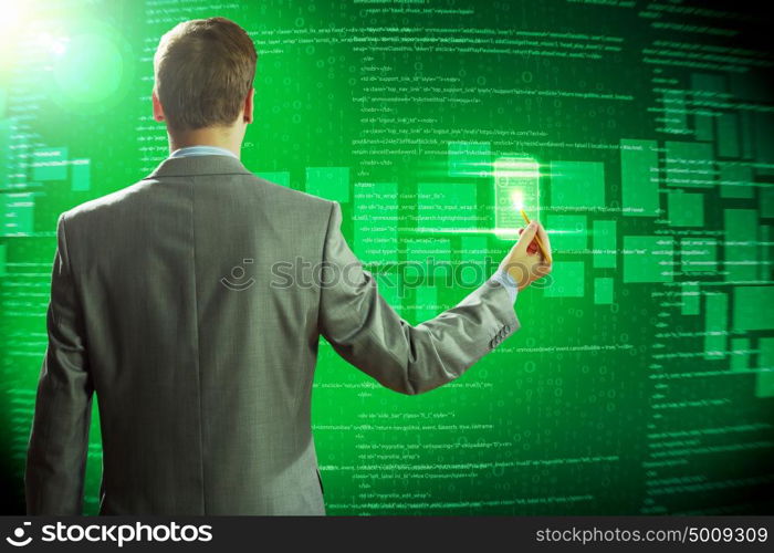 Computer technologies. Rear view of businessman touching icon of media screen