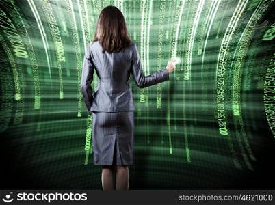 Computer technologies. Rear view of busineswoman touching digital screen