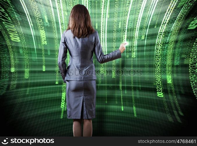 Computer technologies. Rear view of busineswoman touching digital screen