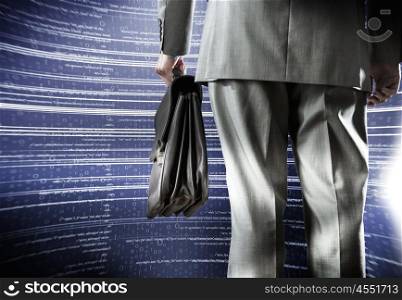 Computing concept. Bottom view of businessman with suitcase in hand