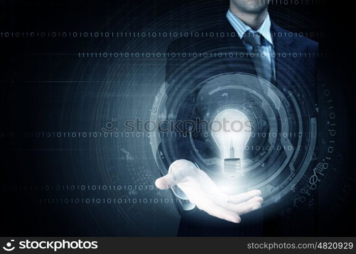 Computing concept. Close up of businessman holding bulb in palm