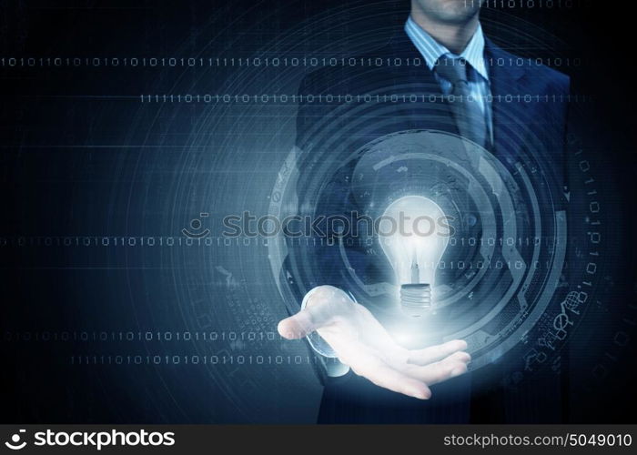 Computing concept. Close up of businessman holding bulb in palm