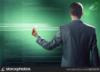 Computing concept. Rear view of businessman touching digital screen