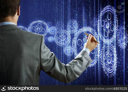 Computing concept. Rear view of businessman touching digital screen