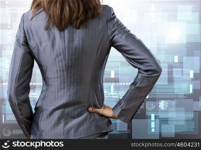 Computing concept. Rear view of businesswoman against digital background