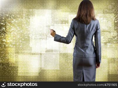 Computing concept. Rear view of businesswoman drawing on media screen