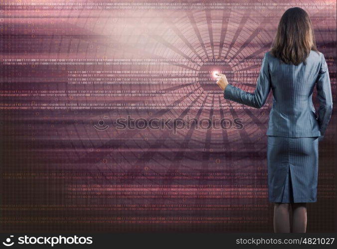 Computing concept. Rear view of businesswoman touching icon of digital screen