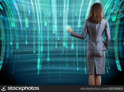 Computing concept. Rear view of businesswoman touching icon of digital screen