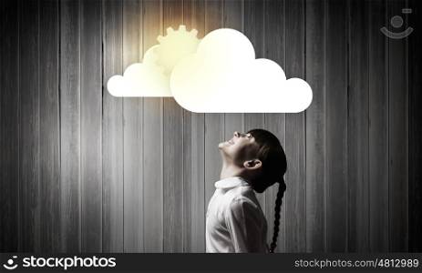 Computing concept. Side view of cute girl and media cloud above her head