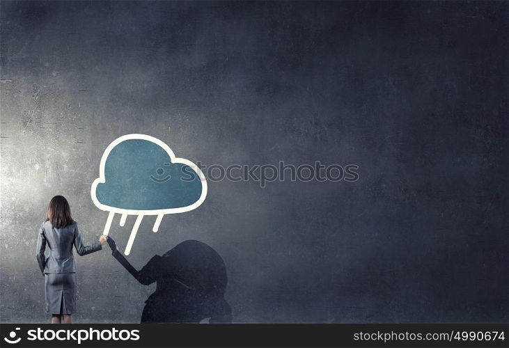 Computing connection. Rear view of businesswoman drawing cloud concept on wall