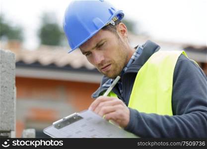 concentrated builder using a clipboard outdoors