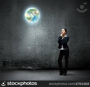 Concentrated businesswoman. Image of thoughtful businesswoman looking at planet earth