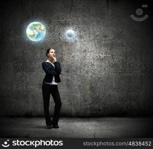 Concentrated businesswoman. Image of thoughtful businesswoman looking at planet earth