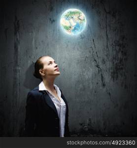 Concentrated businesswoman. Image of thoughtful businesswoman looking at planet earth