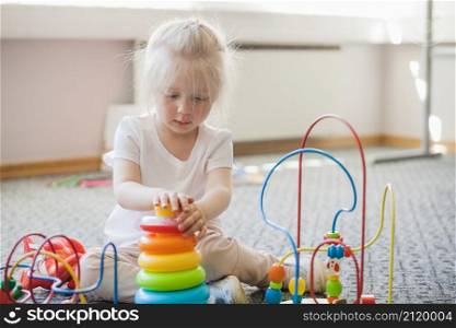 concentrated kid spending time with toys