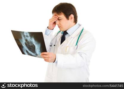Concentrated medical doctor holding results of pelvis roentgen isolated on white&#xA;