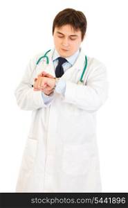 Concentrated medical doctor looking at clock isolated on white&#xA;