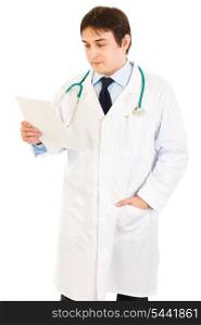 Concentrated medical doctor reading document isolated on white&#xA;
