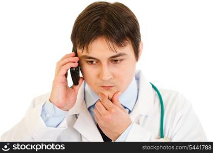 Concentrated medical doctor talking on mobile phone isolated on white&#xA;