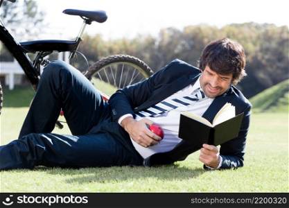 concentrated worker reading book grass