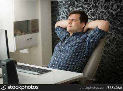 Concentrated young man working on computer at home office