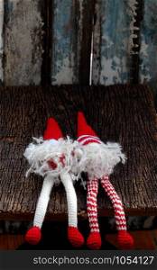 Concept celebration winter seasonal with two red Christmas gnome ornament relax together, handmade stuffed toy crochet from yarn wear long hat, white beard so cute for decoration dec festival season