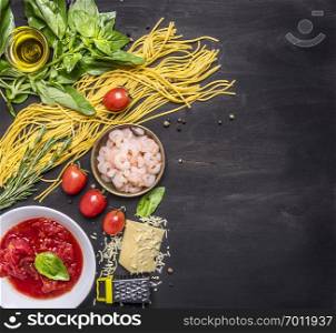 concept cooking pasta with shrimp, tomato paste, cheese and herbs on wooden rustic background top view border ,place for text