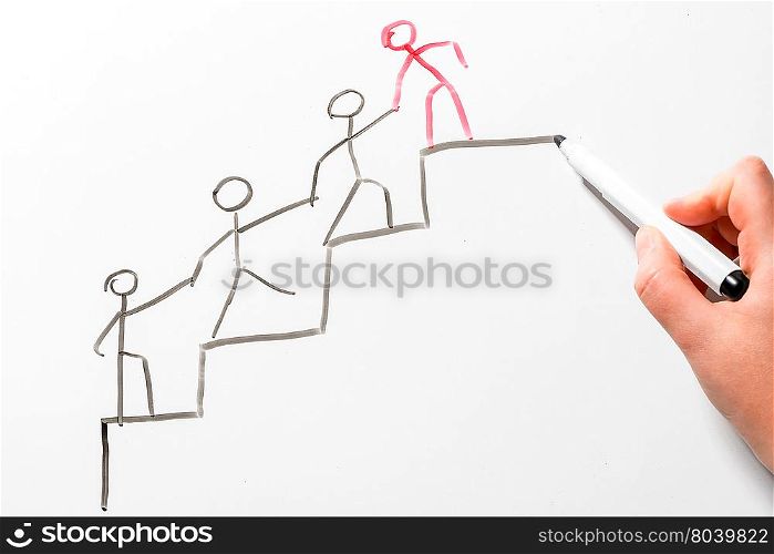 concept drawing on the blackboard - helping a colleague to move up the career ladder