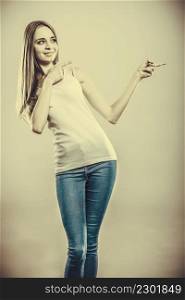 Concept girl advertisement product. Young woman casual style point finger showing something to side empty copy space.