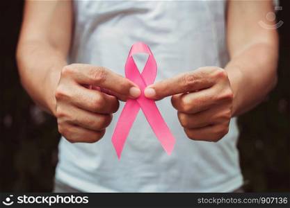 concept healthcare and medicine. hand holding pink ribbon. breast cancer awareness. sign of hope