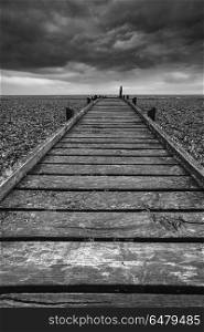 Concept image of path to nowhere in desolate beach black and whi. Conceptual image of path to nowhere in black and white beach landscape
