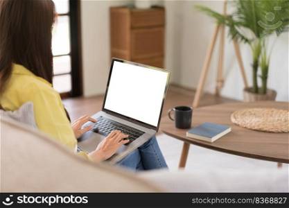 Concept of activity in home, Young woman is chatting with friends on laptop while sitting on couch.