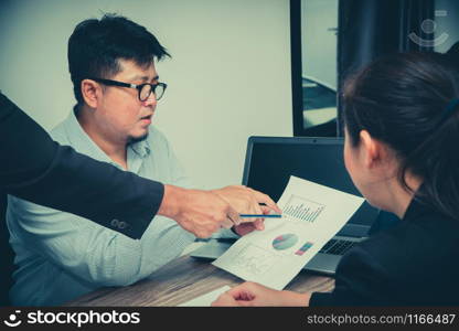 Concept of Asian startup diversity teamwork meeting.Teamwork process in coworking office. Annual sales meeting With a graph showing the income of each month